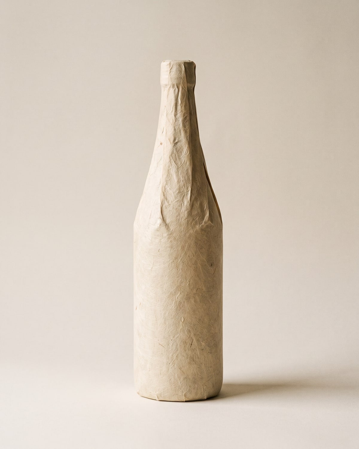 A 720ml junmai sake bottle with an unbleached washi-paper label, on white