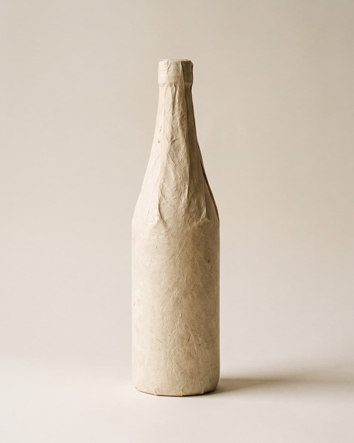 A 720ml junmai sake bottle with an unbleached washi-paper label, on white